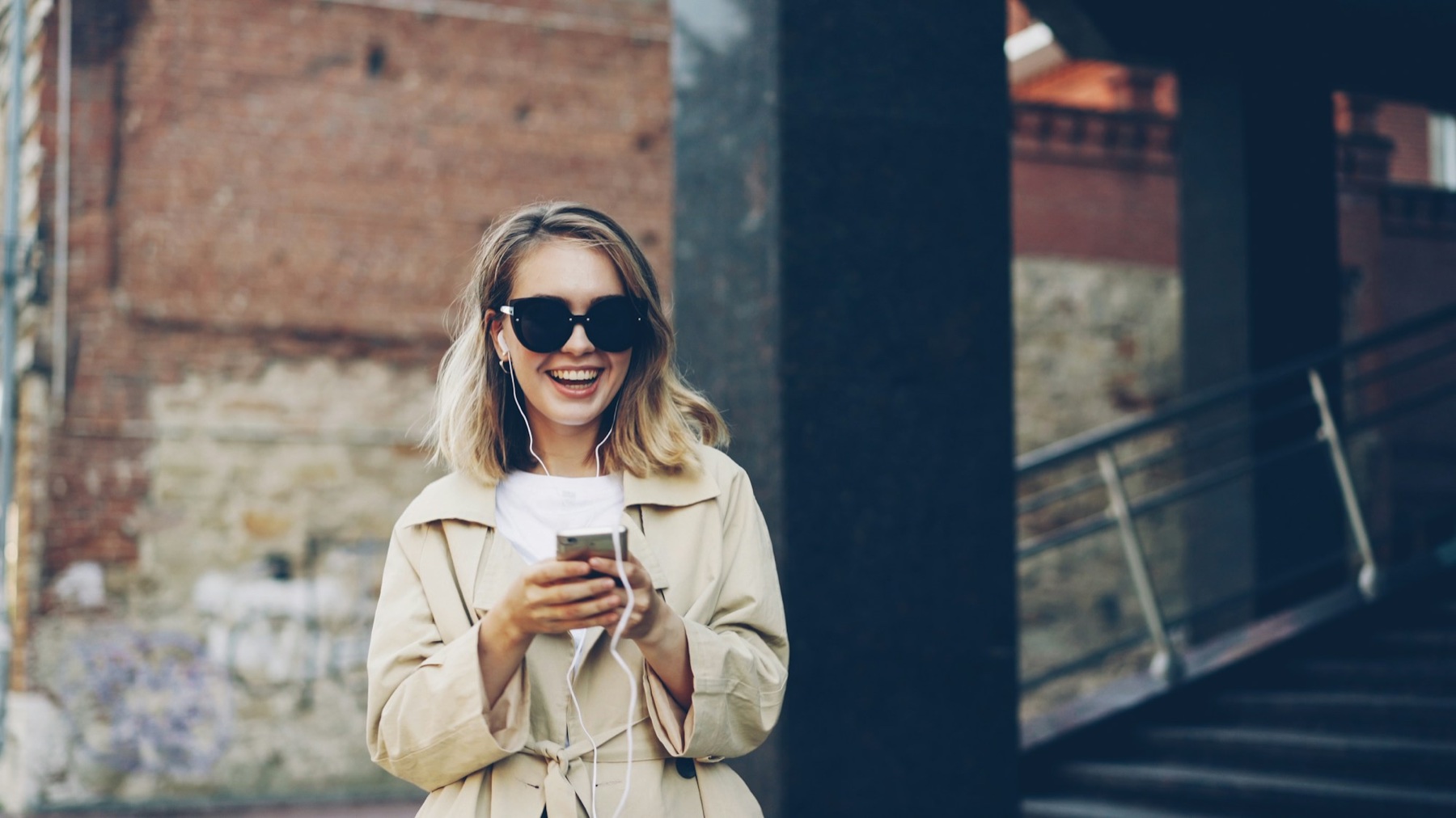 Woman smiling with her phone